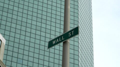 Wall Street sign on the side of a building in New York