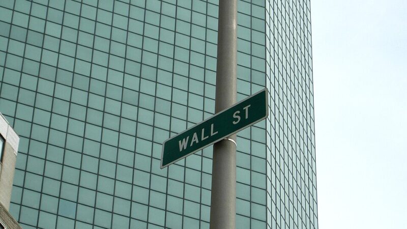 Wall Street sign on the side of a building in New York