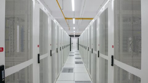 Rows of server racks in a modern data centre