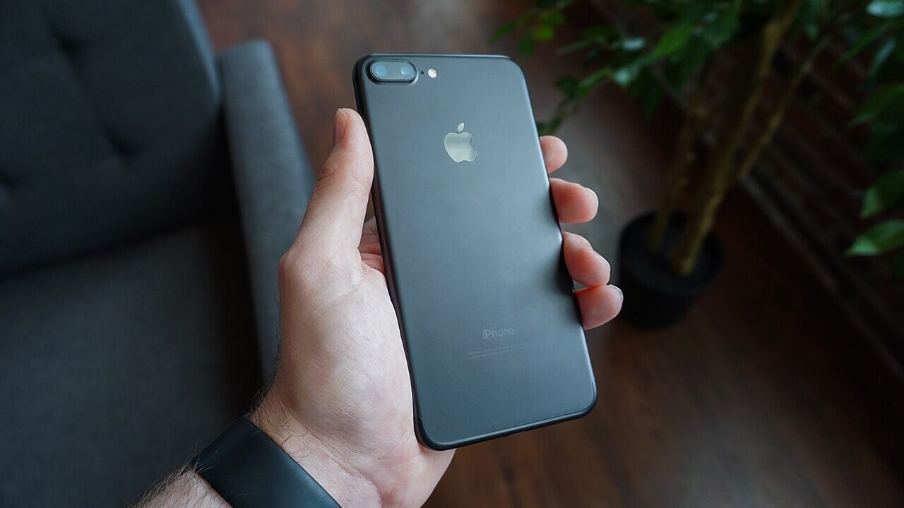 Hand holding a black smartphone