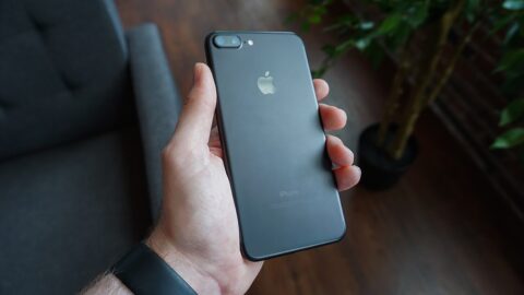 Hand holding a black smartphone